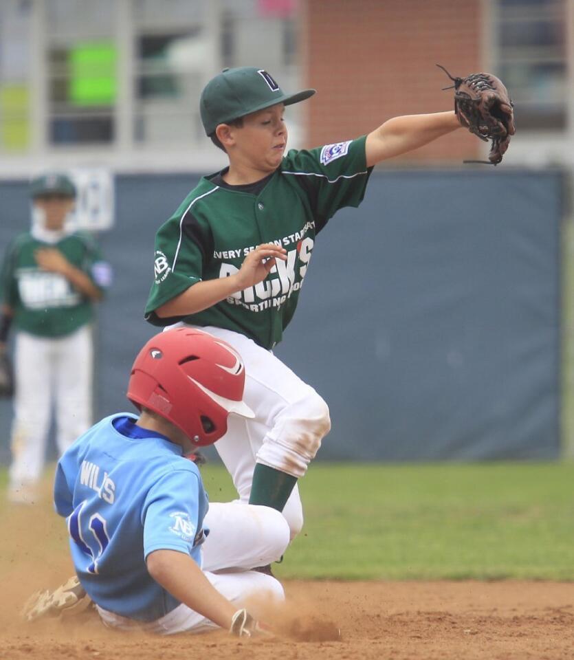 Dick's Sporting Goods' Kieran Sidebotham, top, makes the catch to beat Earthpack's Mathew Wilks, bottom, to second base.