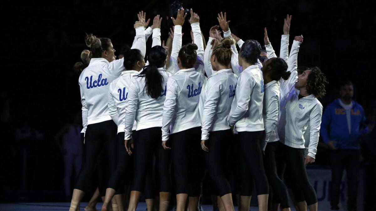 The UCLA gymnastics team comes together ahead of a Pac-12 meet against Arizona State at Pauley Pavilion on January 21, 2019.