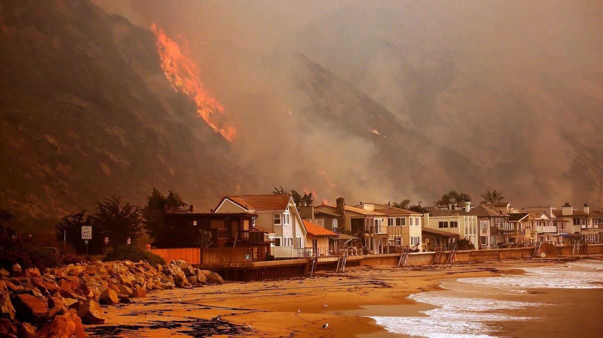 Homes on the Pacific Ocean between Solimar and Faria Beaches North of downtown Ventura as the Thomas Fire burns in the hills on the North side of the 101 freeway.