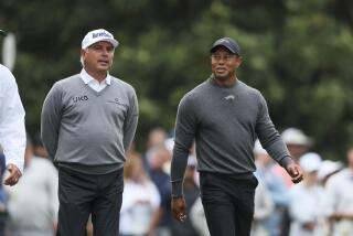 Fred Couples, left, and Tiger Woods talk as they walk down the second fairway after their tee shots during a practice round for the Masters golf tournament at Augusta National Golf Club in Augusta, Ga., Tuesday, April 9, 2024. (Jason Getz/Atlanta Journal-Constitution via AP)