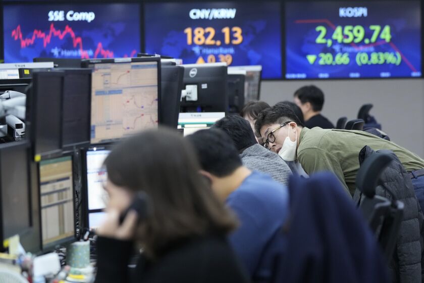Currency traders work at the foreign exchange dealing room of the KEB Hana Bank headquarters in Seoul, South Korea, Monday, Feb. 6, 2023. Asian stock markets sank Monday after strong U.S. jobs data fanned fears of more interest rate hikes to cool inflation. (AP Photo/Ahn Young-joon)