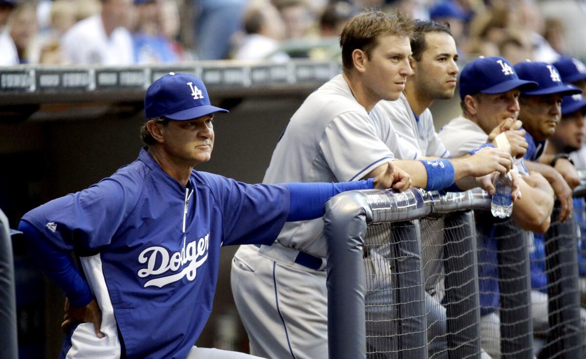 Dodgers Manager Don Mattingly watches from the dugout during a game against the Milwaukee Brewers.