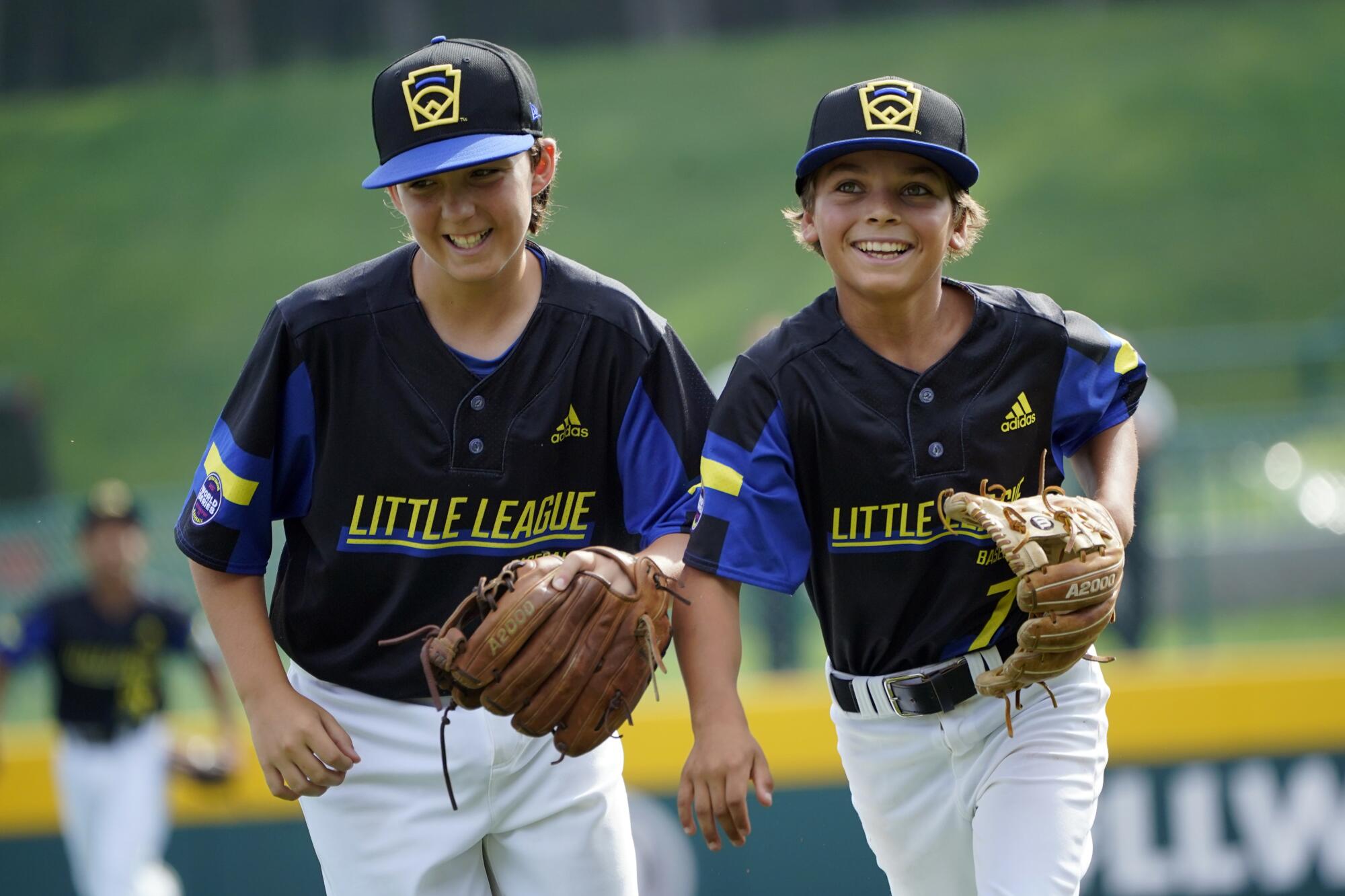 Torrance, Calif.'s Dominic Golia and pitcher Xavier Navarro smile as the run off the field