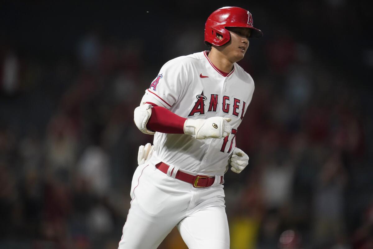 Angels' Shohei Ohtani rounds first base after a solo home run.