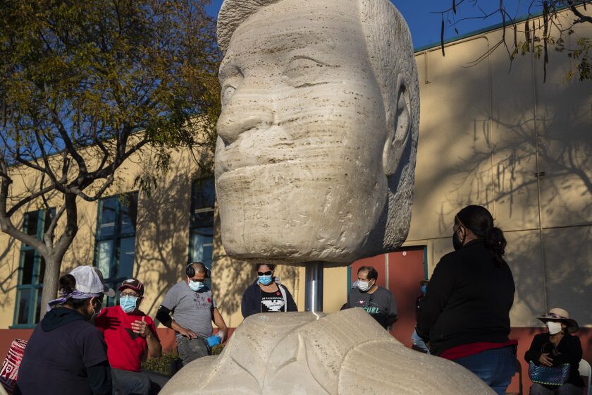 OXNARD, CA - FEBRUARY 10: Members of the United Farm Workers hold an organizing event near a sculpture of Cesar Chavez on Wednesday, Feb. 10, 2021 in Oxnard, CA. (Brian van der Brug / Los Angeles Times)