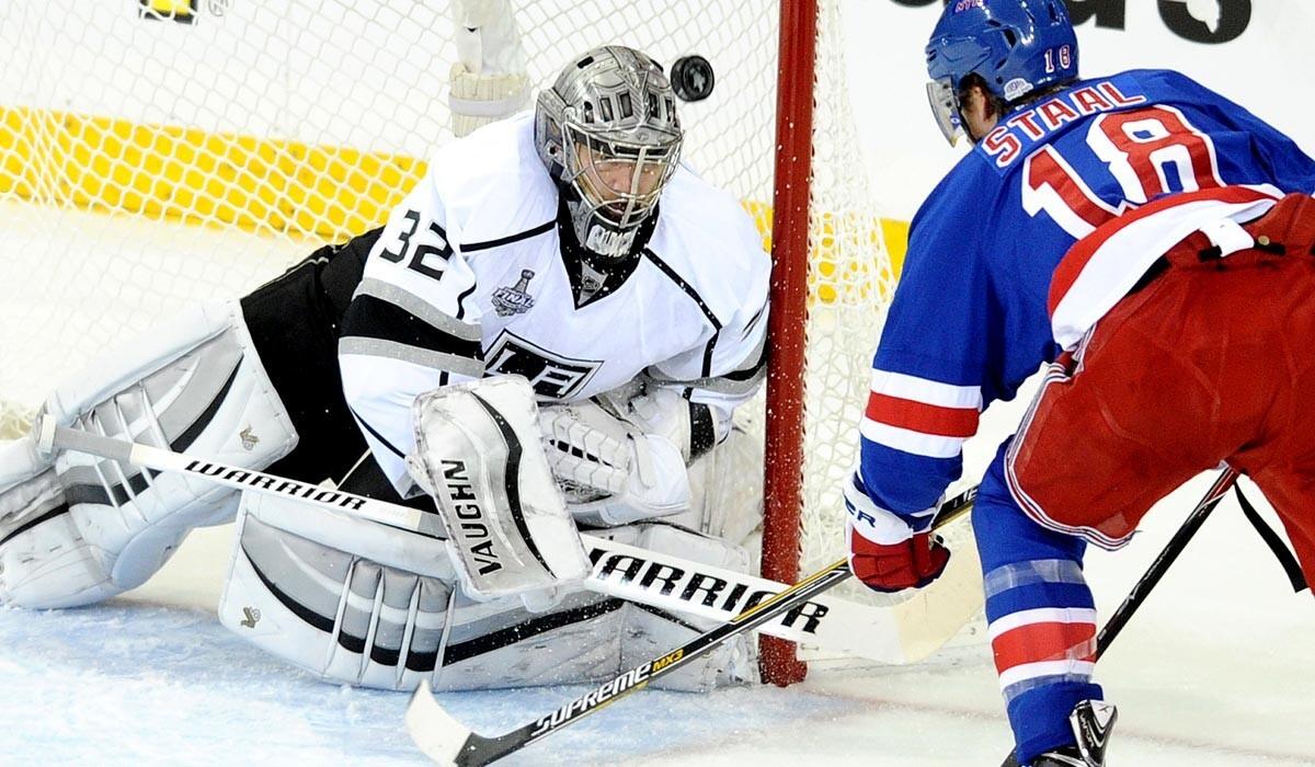 Kings goaltender Jonathan Quick deflects a shot by Rangers defenseman Marc Staal into the air in the first period of Game 4 on Wednesday night in New York.