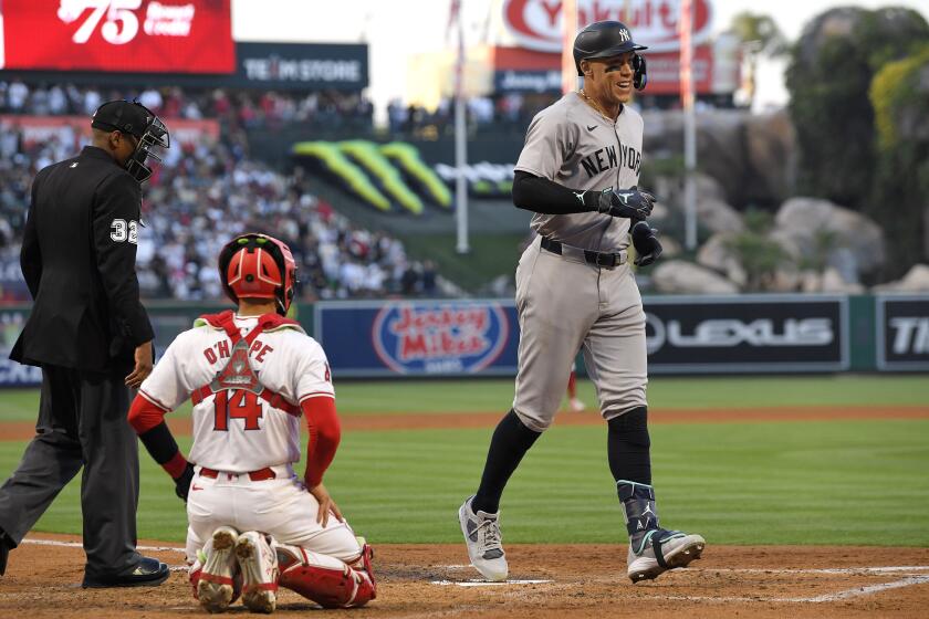 New York Yankees' Aaron Judge, right, scores after hitting a two-run home run.