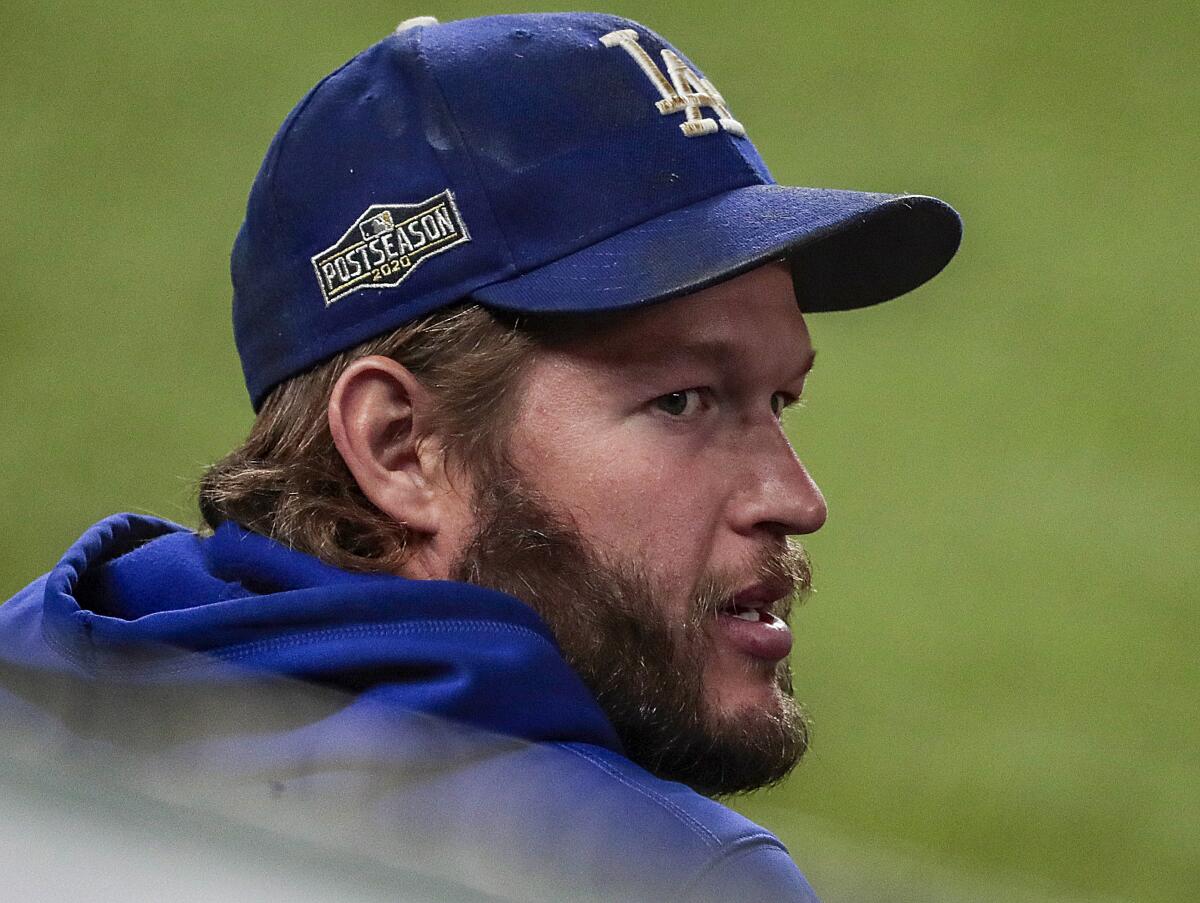 Dodgers pitcher Clayton Kershaw watches from the dugout during Game 2 of the NLCS
