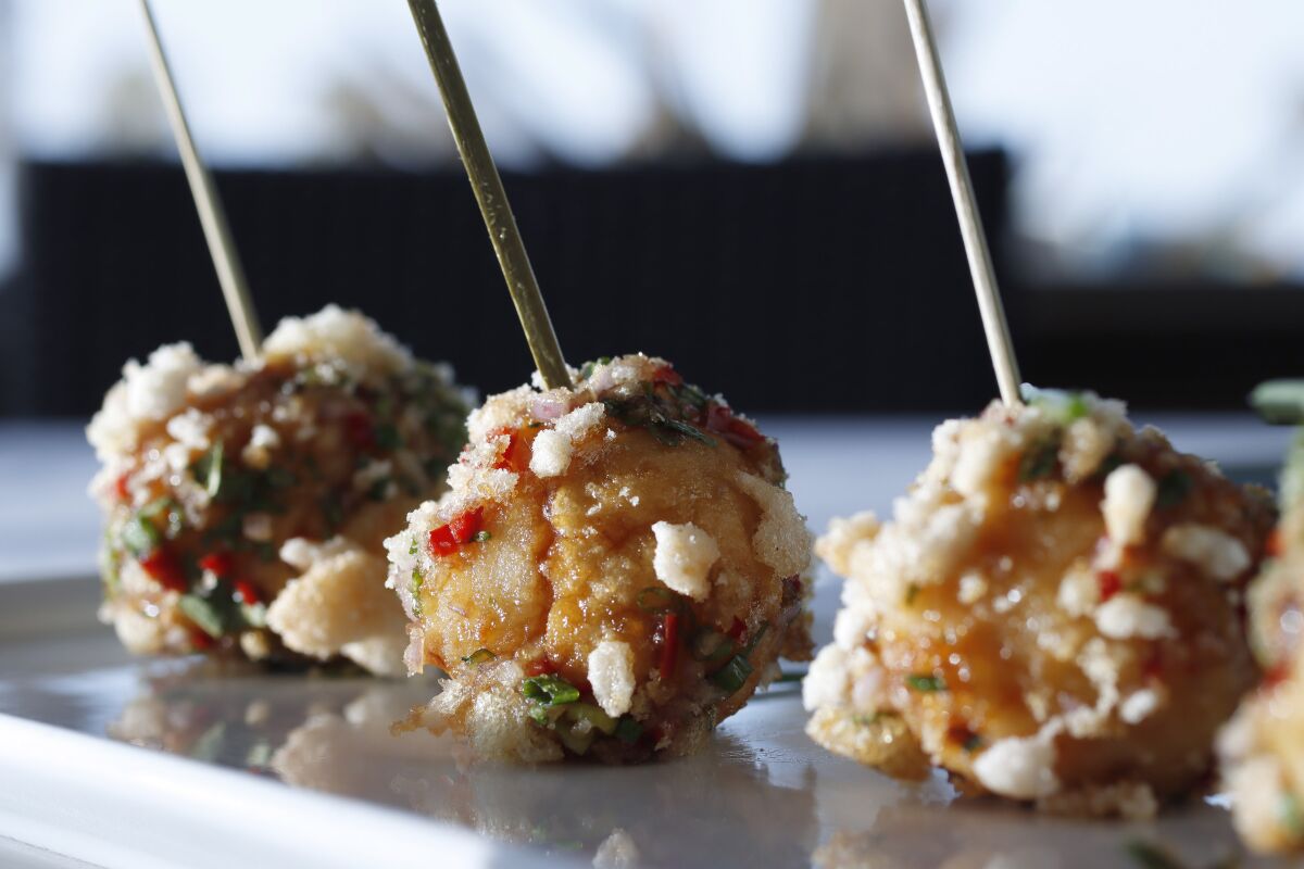 Bola-Bola Shrimp and Fish, a savory snack dipped in a crunchy topping, prepared by chef Evan Cruz.