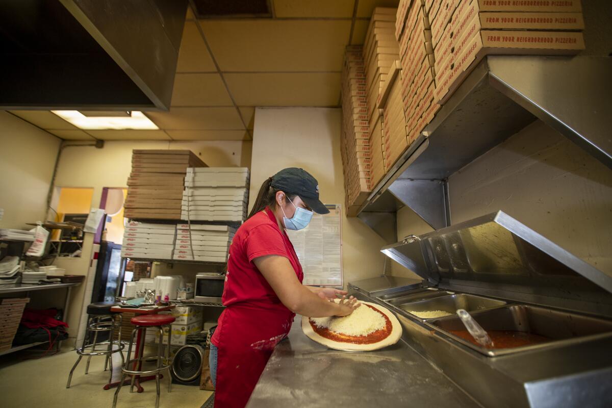 Jocelyn Campos makes pizza at her family's restaurant