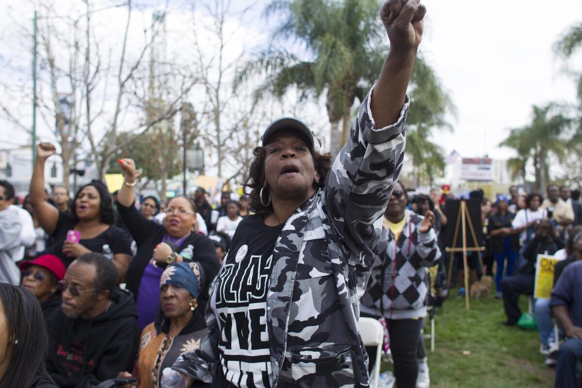 Linda Jay, wearing a Black Lives Matter shirt, joins hundreds of protesters to rally against police abuse and to remember Ezell Ford, a mentally ill black man killed by Los Angeles police, in Leimert Park on Feb. 21, 2015.