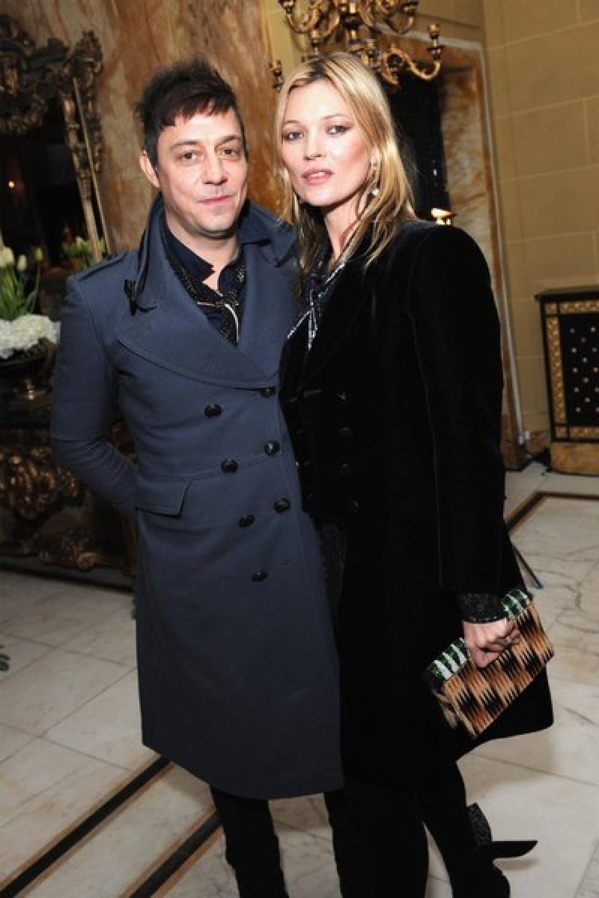 Jamie Hince and Kate Moss pose at miu-miu-london, a temporary women's club in London.