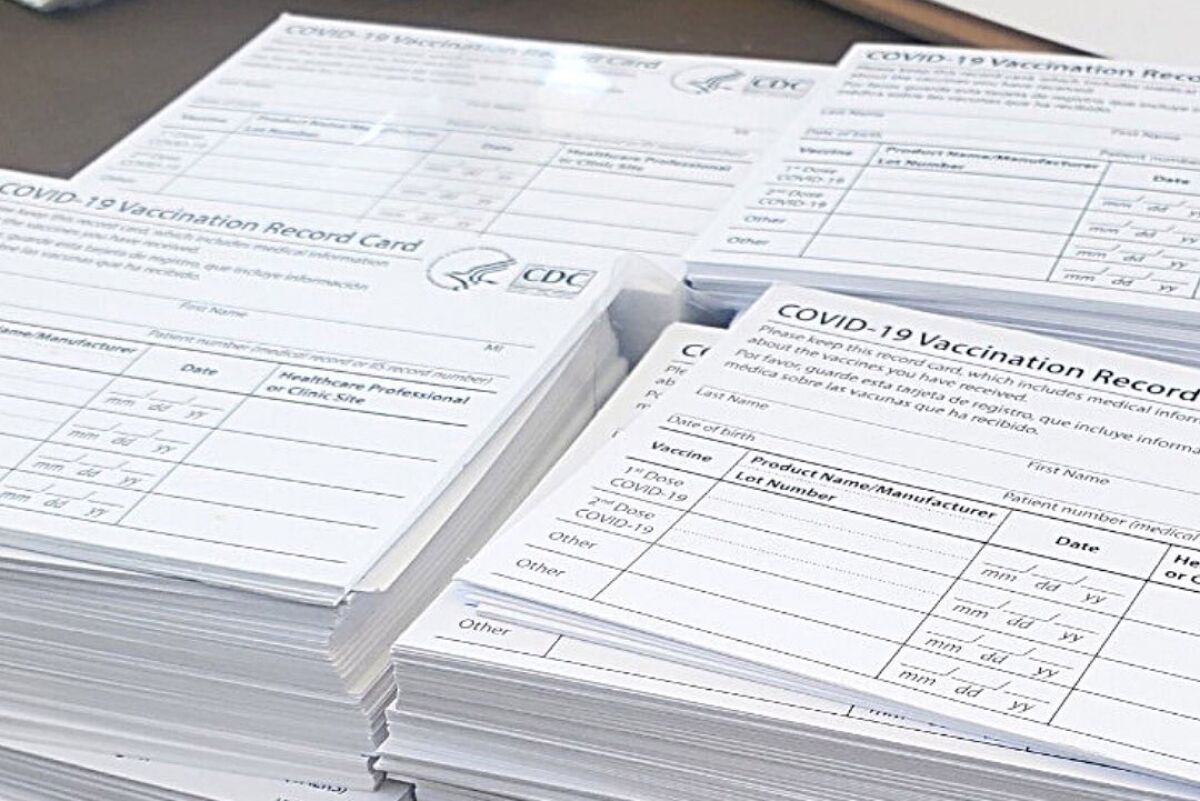 Four stacks of blank CDC COVID-19 Vaccination Record cards