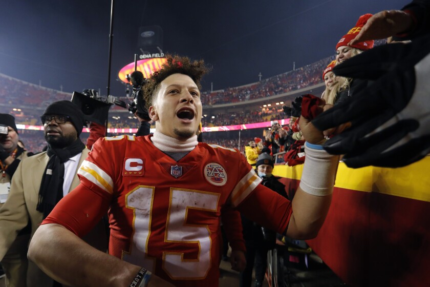 Kansas City Chiefs quarterback Patrick Mahomes (15) celebrates with fans as he walks off the field after an NFL divisional round playoff football game against the Buffalo Bills, Sunday, Jan. 23, 2022, in Kansas City, Mo. The Chiefs won 42-36 in overtime. (AP Photo/Colin E. Braley)