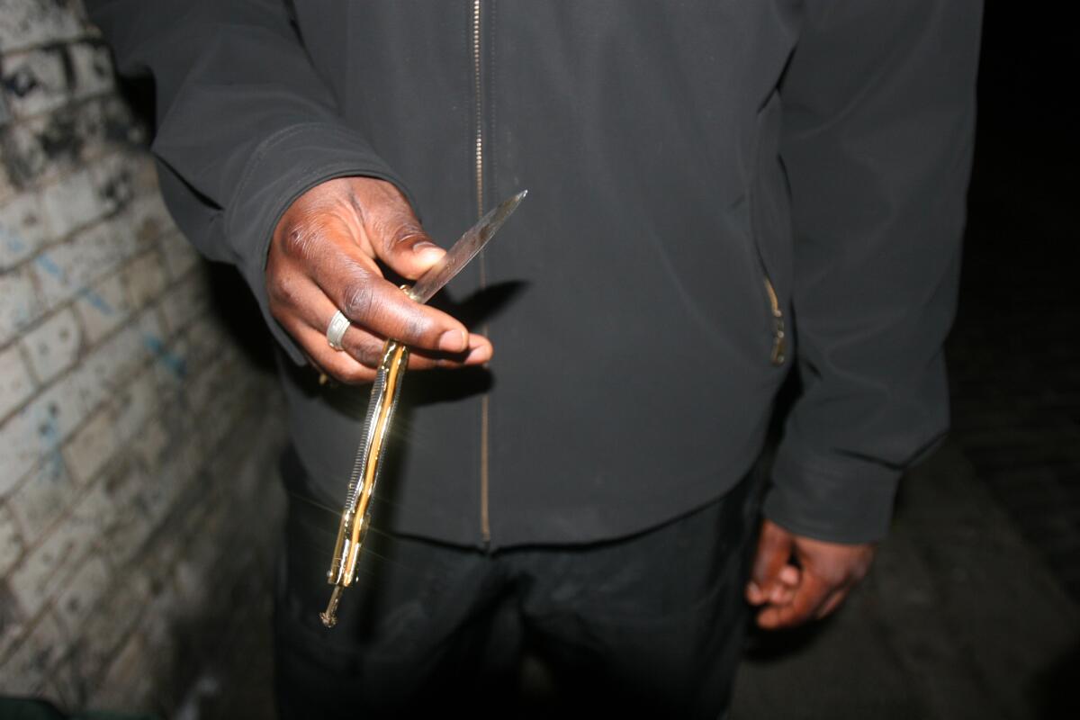 A person holds a butterfly knife. 