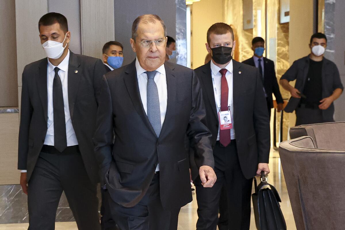 In this photo released by Russian Foreign Ministry Press Service, Russian Foreign Minister Sergey Lavrov, center, arrives to attend a Central and South Asia 2021 conference in Tashkent, Uzbekistan, Friday, July 16, 2021. (Russian Foreign Ministry Press Service via AP)