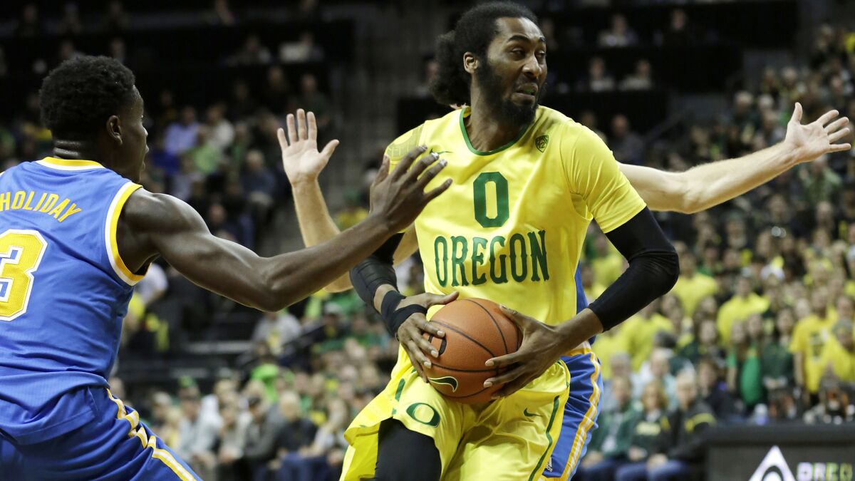 Oregon forward Dwayne Benjamin drives down the lane against UCLA during the first half Saturday.