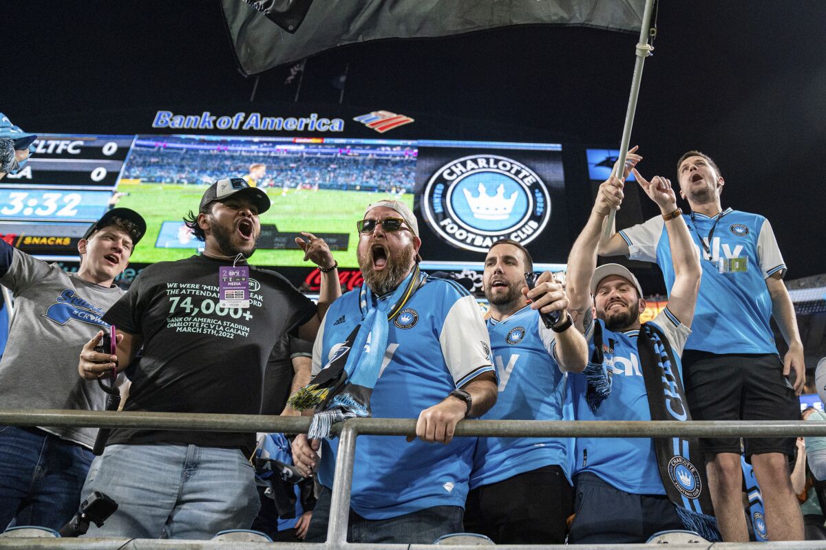 Fans cheer before an MLS soccer match between Charlotte FC and the LA Galaxy in Charlotte, N.C., Saturday, March 5, 2022. (AP Photo/Jacob Kupferman)