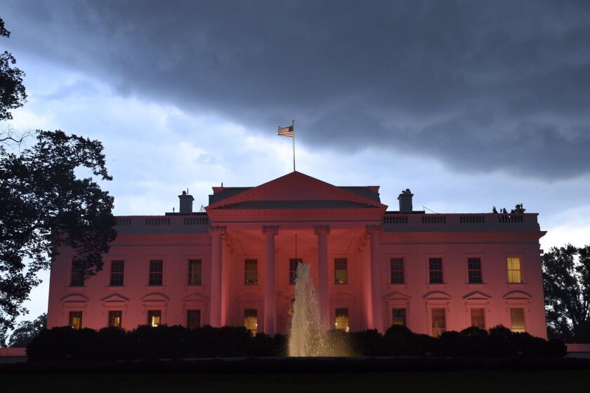 The White House is lit in pink in honor of breast cancer awareness month on Oct. 9.