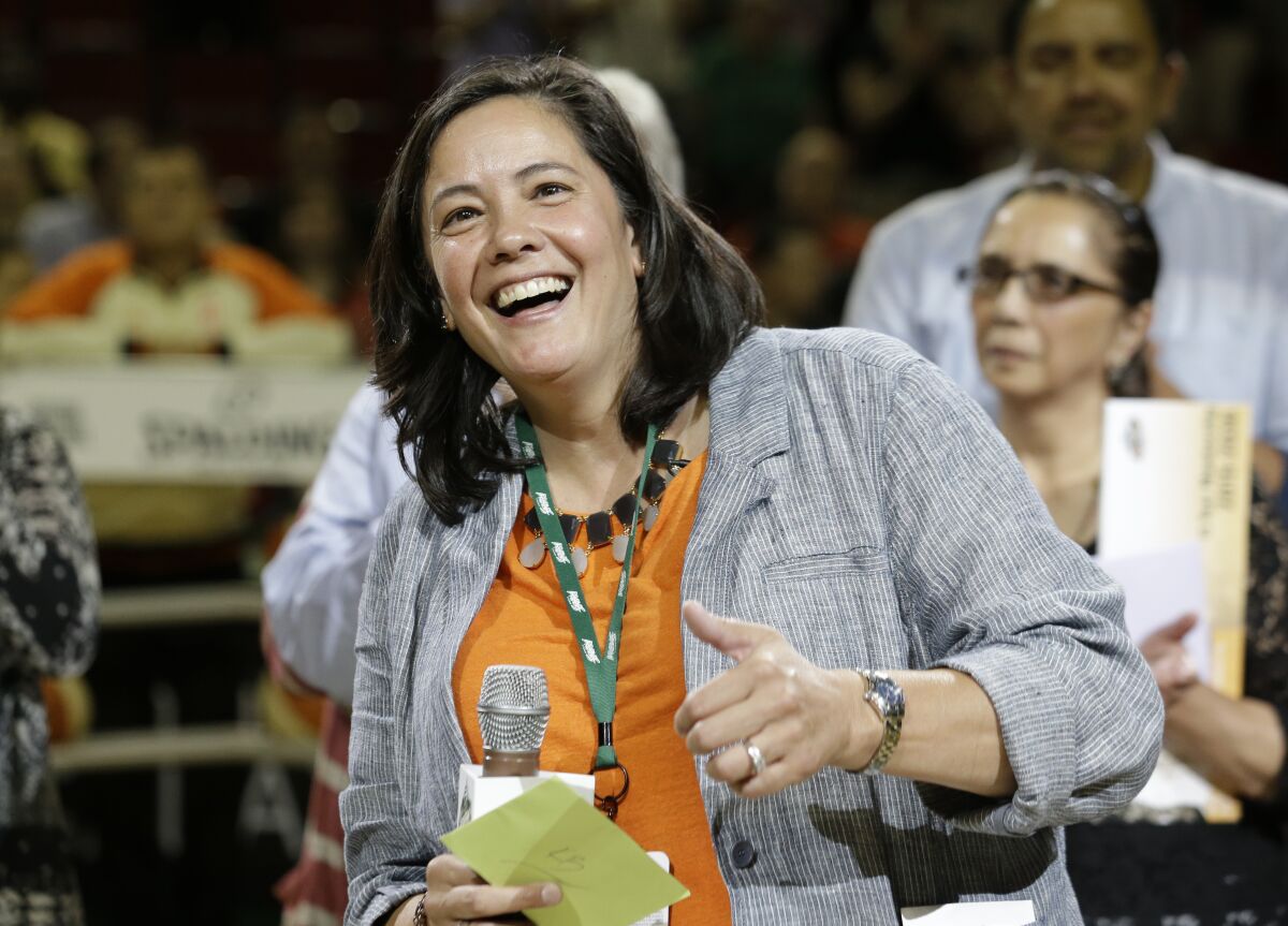 CEO and outgoing president of the Seattle Storm, Karen Bryant, smiles as she is being honored on her final day.