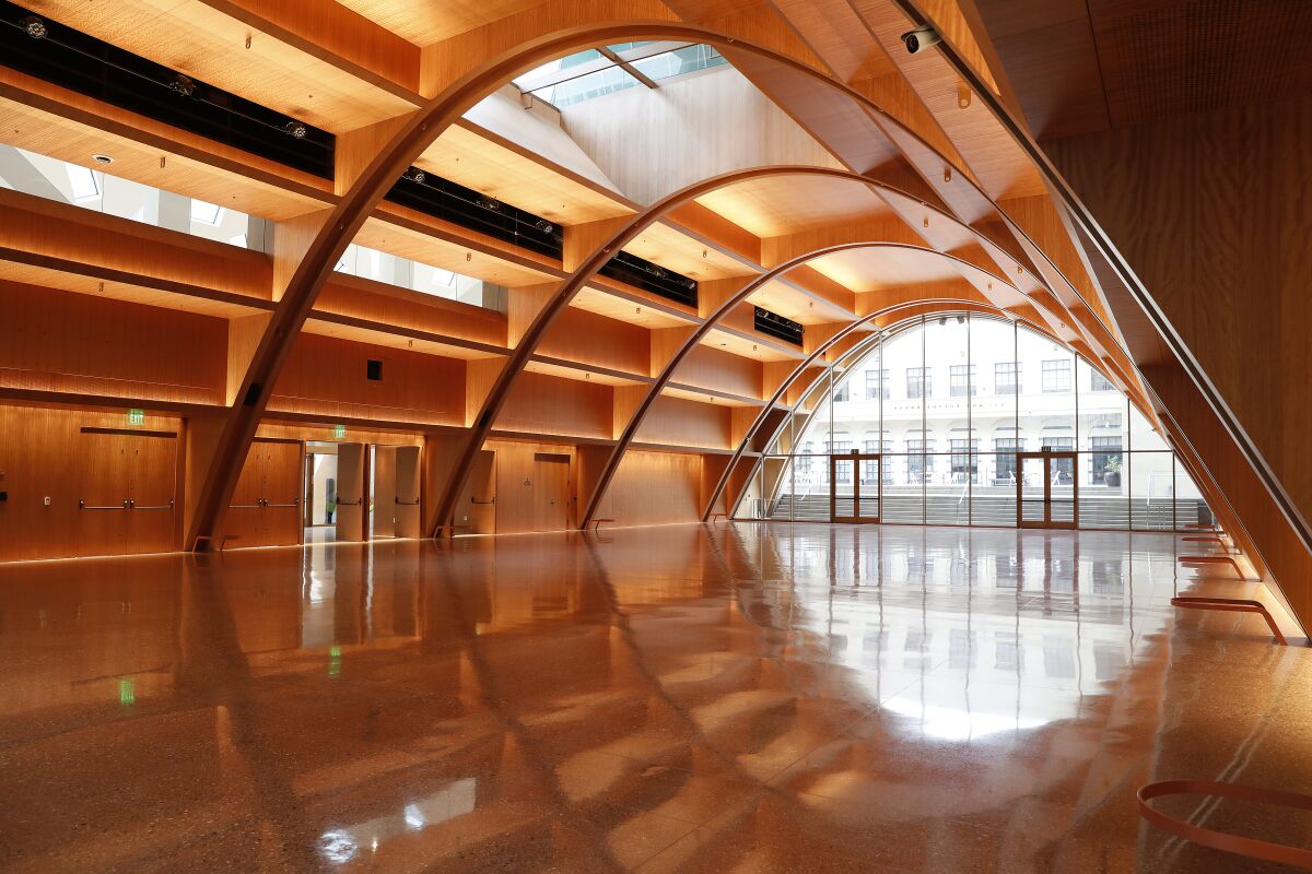 A long open space with an arched ceiling and a glass wall.