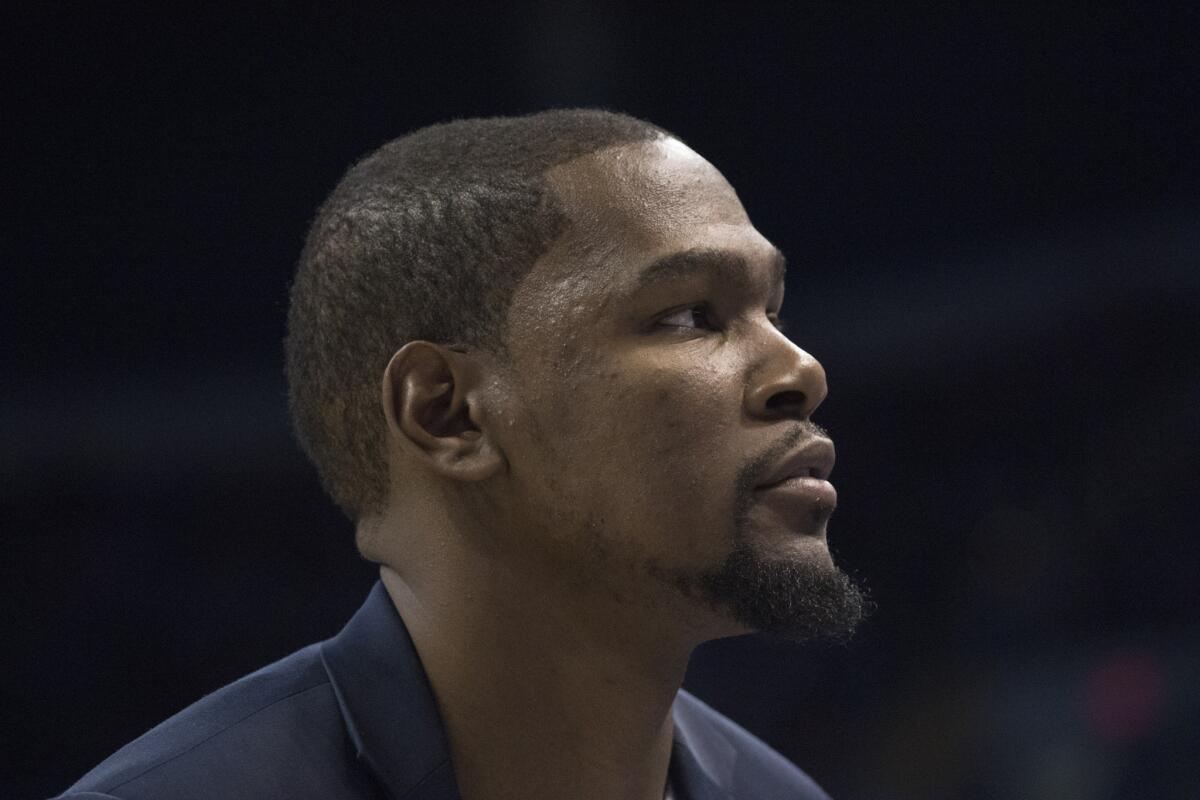 Thunder forward Kevin Durant watches game action against the New Orleans Pelicans from the bench.