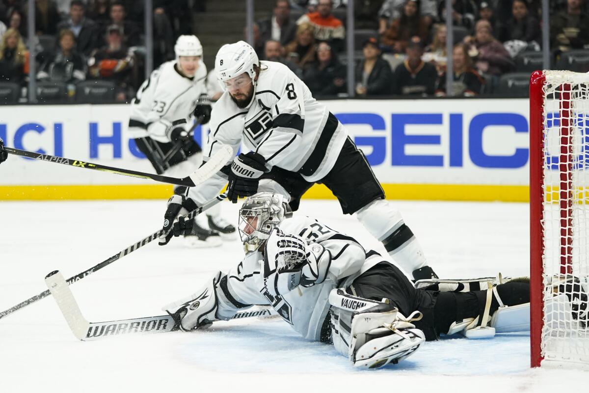 Kings defenseman Drew Doughty, top, helps goaltender Jonathan Quick make a save against the Ducks in the second period.