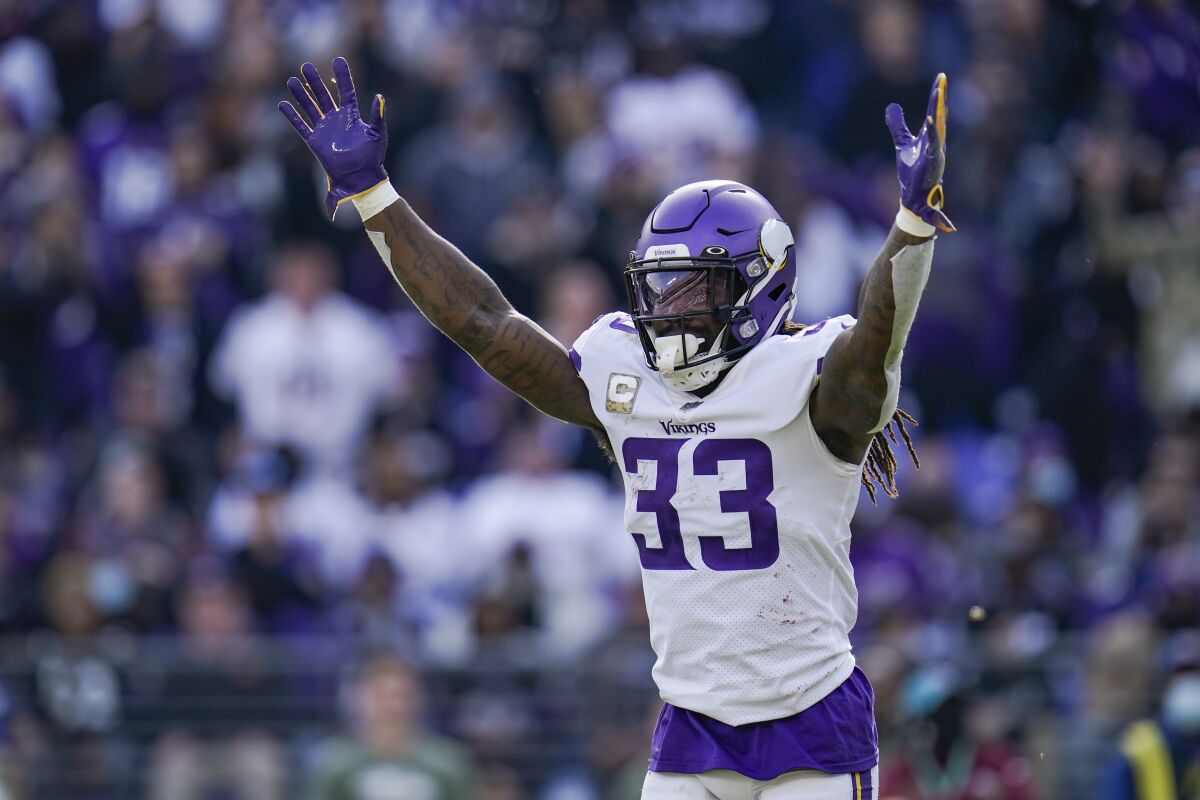 Minnesota Vikings running back Dalvin Cook celebrates a touchdown by quarterback Kirk Cousins during the first half of an NFL football game against the Baltimore Ravens, Sunday, Nov. 7, 2021, in Baltimore. (AP Photo/Julio Cortez)