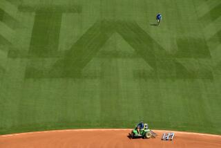 LOS ANGEL;ES, CALIFORNIA APRIL 8, 2021-Work crews prepare the field at Dodger Stadium for opening day Friday. (Wally Skalij/Los Angeles Times)