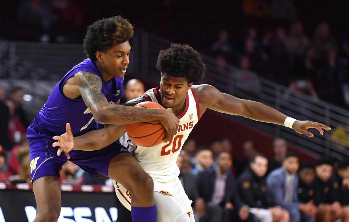 USC's Ethan Anderson goes for a steal against Washington's Jaden McDaniels but is called for a foul during the first half of a game Feb. 13 at Galen Center.