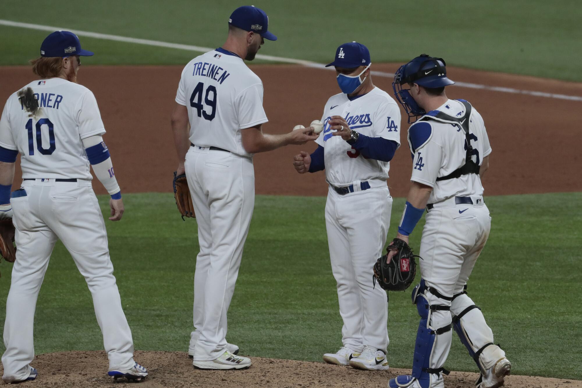 Dodgers manager Dave Roberts pulls reliever Blake Treinen from the game during the ninth inning.