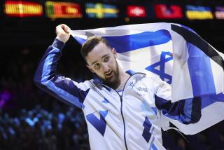 Gold medal winner Israel's Artem Dolgopyat celebrates with the national flag.