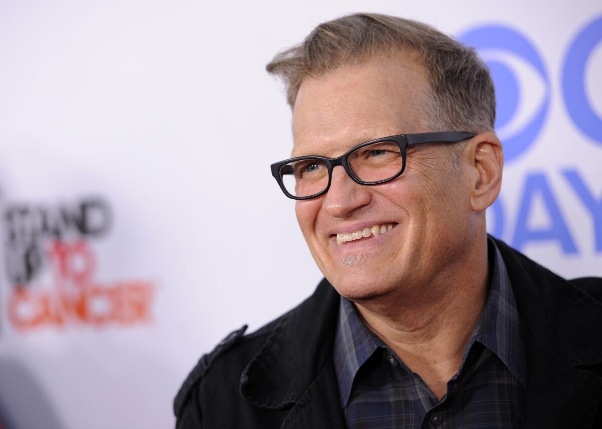 Drew Carey, pictured in 2013, offered a reward to help police find those who allegedly dumped a bucket of water, urine and spit on a boy.