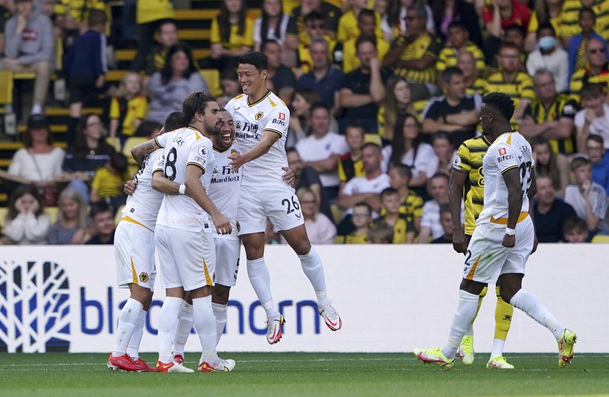 Wolverhampton Wanderers players celebrate after Watford's Francisco Sierralta scores an own goal during their English Premier League soccer match against Watford at Vicarage Road, Watford, England, Saturday, Sept. 11, 2021. (Zac Goodwin/PA via AP)