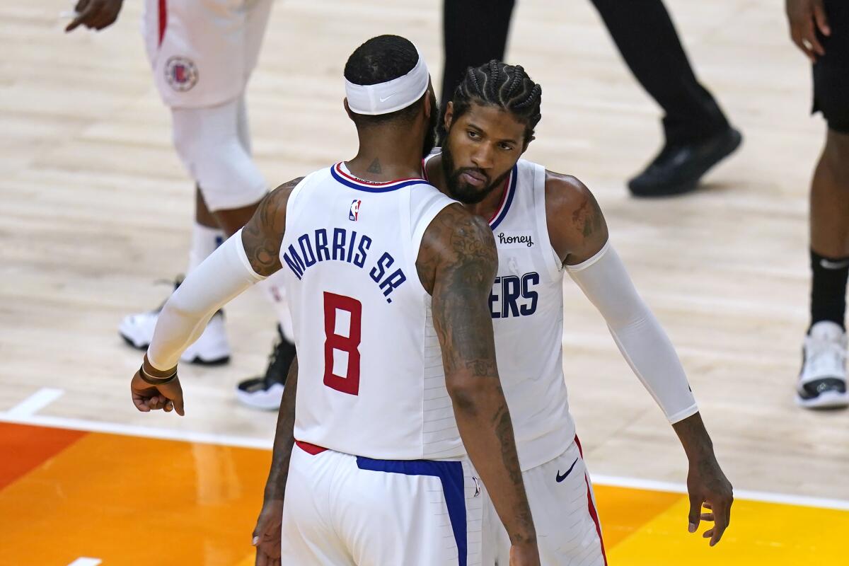 Clippers forwards Marcus Morris Sr. and Paul George congratulate each other.