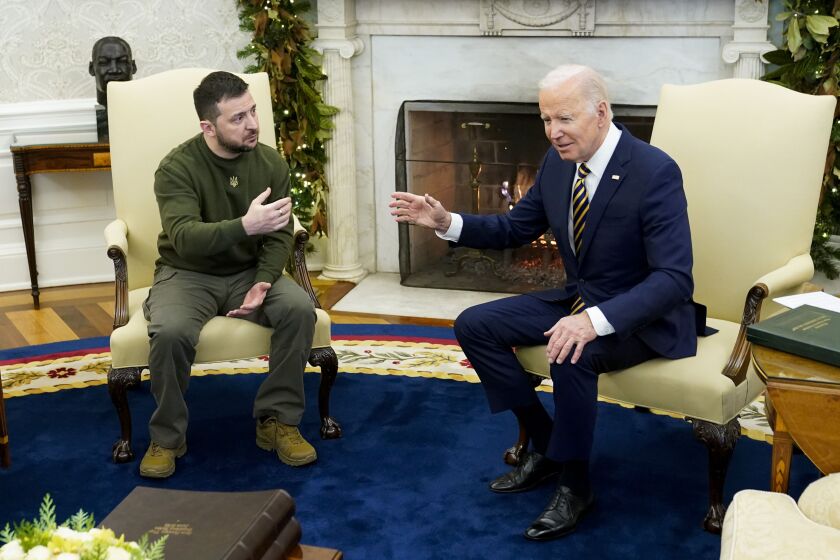 FILE - President Joe Biden speaks with Ukrainian President Volodymyr Zelenskyy as they meet in the Oval Office of the White House, Dec. 21, 2022, in Washington. One year ago, Biden braced for the worst as Russia massed troops in preparation to invade Ukraine. But as Russia’s deadly invasion reaches the one year mark, Kyiv stands and Ukraine has exceeded even its own expectations. (AP Photo/Patrick Semansky, File)