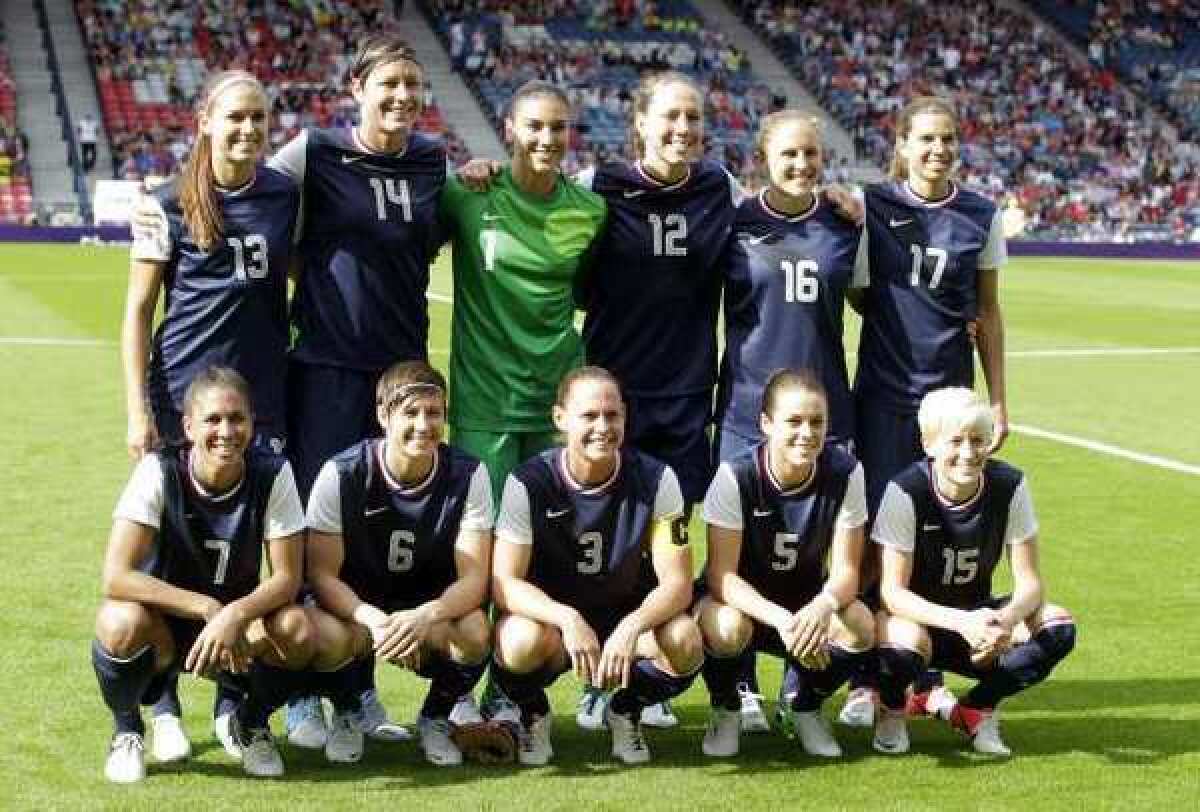 Members of the U.S. women's Olympic soccer team pose for a group photo before taking on France in their 2012 group play opener on Wednesday in Glasgow, Scotland, a 4-2 U.S. win.
