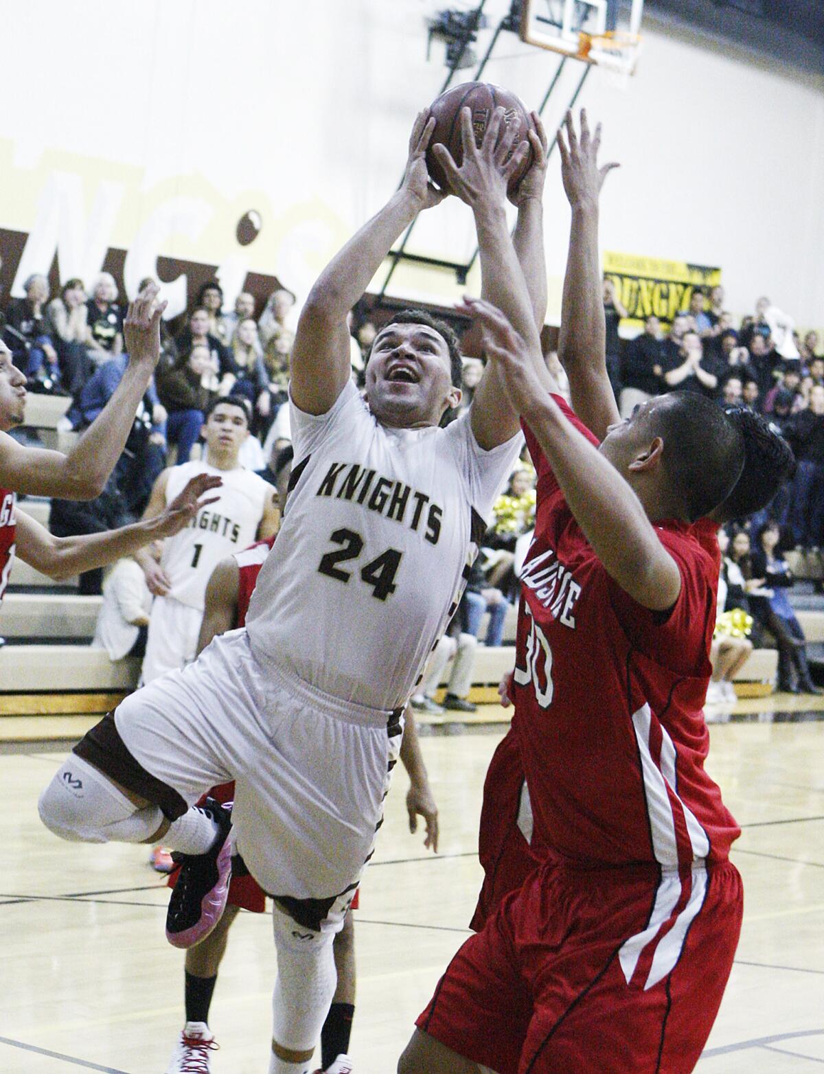 St. Francis' Noah Willerford drives to the basket to shoot against Gladstone's Manny Chavira in a CIF quarterfinal boys basketball game at St. Francis High School in La Canada Flintridge on Tuesday, February 25, 2014.