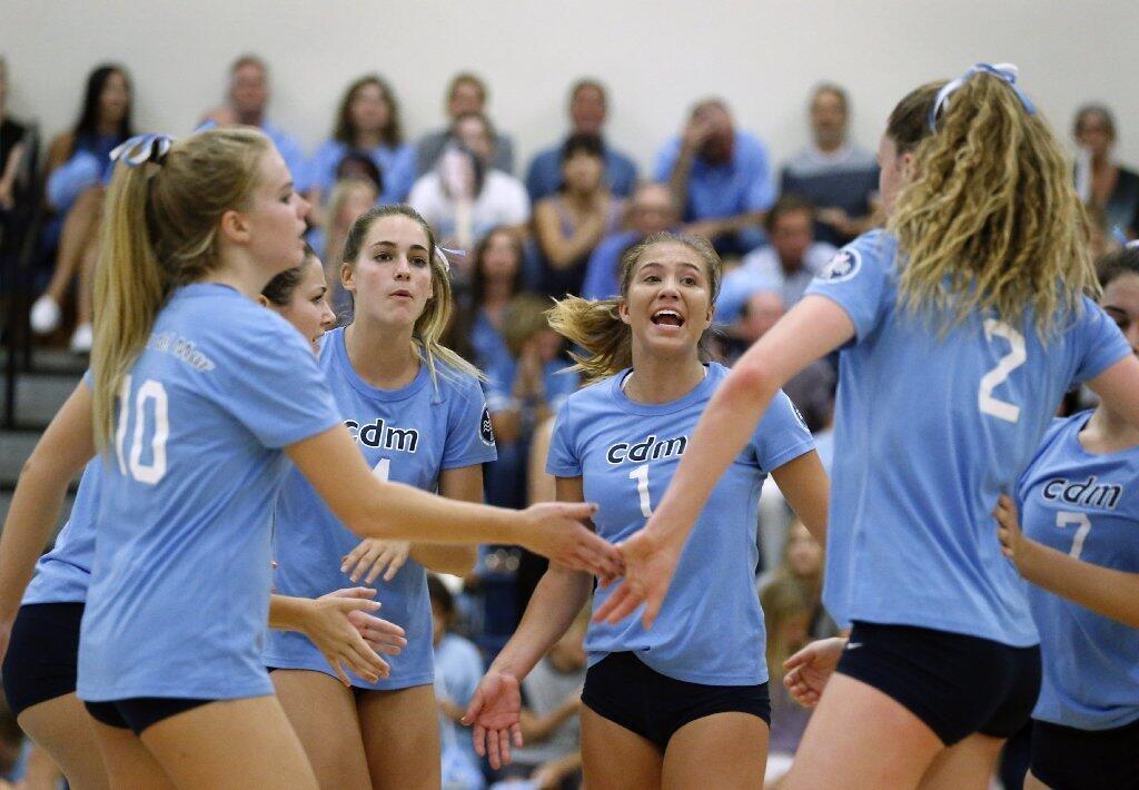 From left, Corona del Mar's Christina Davenport, Ashley Humphreys, Alexa Bonanno and Kendall Kipp celebrate in the first set of the Battle of the Bay.