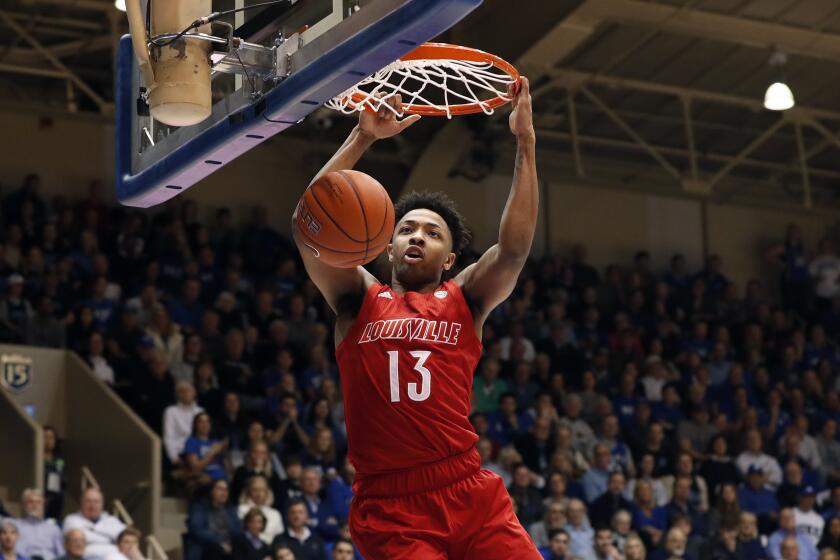 Louisville guard David Johnson (13) dunks against Duke during the first half of an NCAA college basketball game in Durham, N.C., Saturday, Jan. 18, 2020. (AP Photo/Gerry Broome)