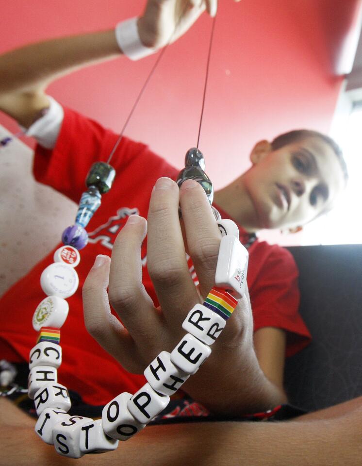 Christopher Wilke, 12, of Burbank, talks about a strand of beads he has accumulated at Children's Hospital Los Angeles for treatment of a rare disease he is battling on Monday, March 3, 2014. The disease is a a bile duct cancer that is rare for adults, and nearly unheard of for children, so the parents are hoping what can be learned from the treatment of Christopher will help future cases because a lot of what is being done for him is designed for adults.