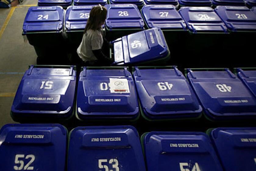 Supervisor Peggy Washington, 50, moves bins at the Central City East Assn.'s 20,000-square-foot warehouse, where the homeless have long stored their belongings. Audio Slideshow>>>