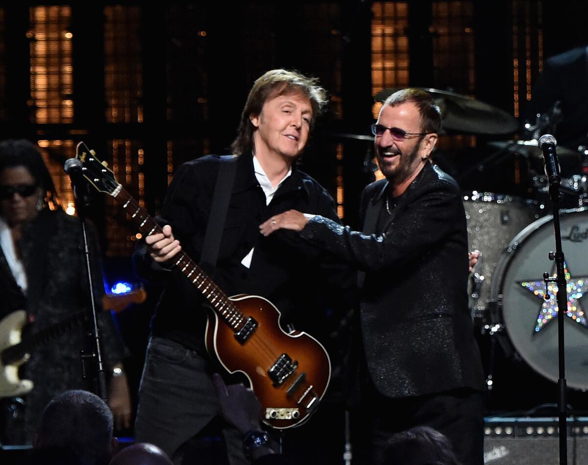 Paul McCartney, left, and inductee Ringo Starr perform onstage during the 30th Annual Rock and Roll Hall of Fame induction ceremony on April 18 in Cleveland.