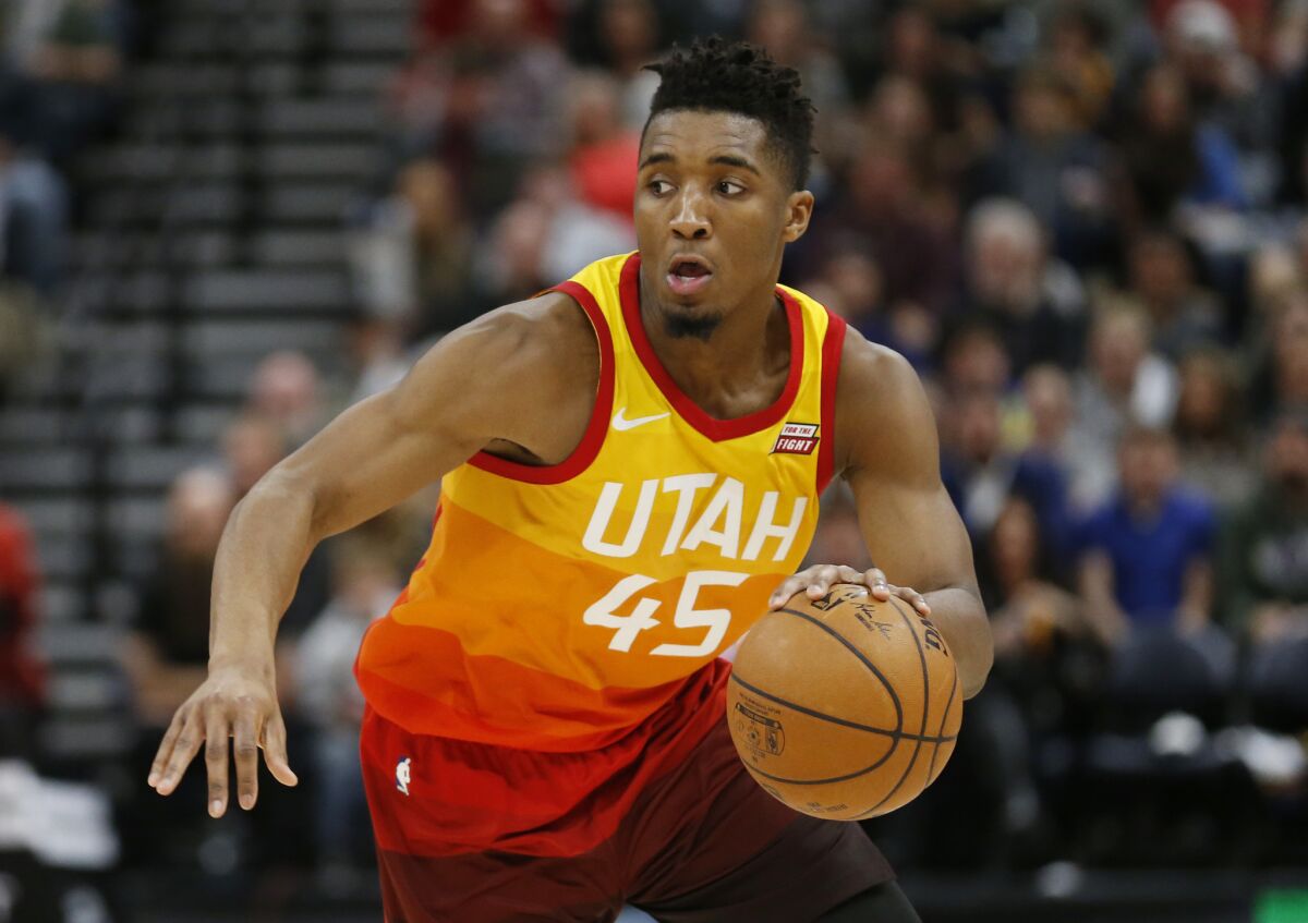 FILE- In this Feb. 9, 2018, file photo, Utah Jazz guard Donovan Mitchell (45) drives up court in the second half during an NBA basketball game against the Charlotte Hornets in Salt Lake City. Mitchell and Philadelphia 76ers' Ben Simmons, the leading rookie of the year candidates, will play together Friday, Feb. 16, when the NBA's best first- and second-year players compete in the Rising Stars in Los Angeles to tip off All-Star weekend. (AP Photo/Rick Bowmer, File)