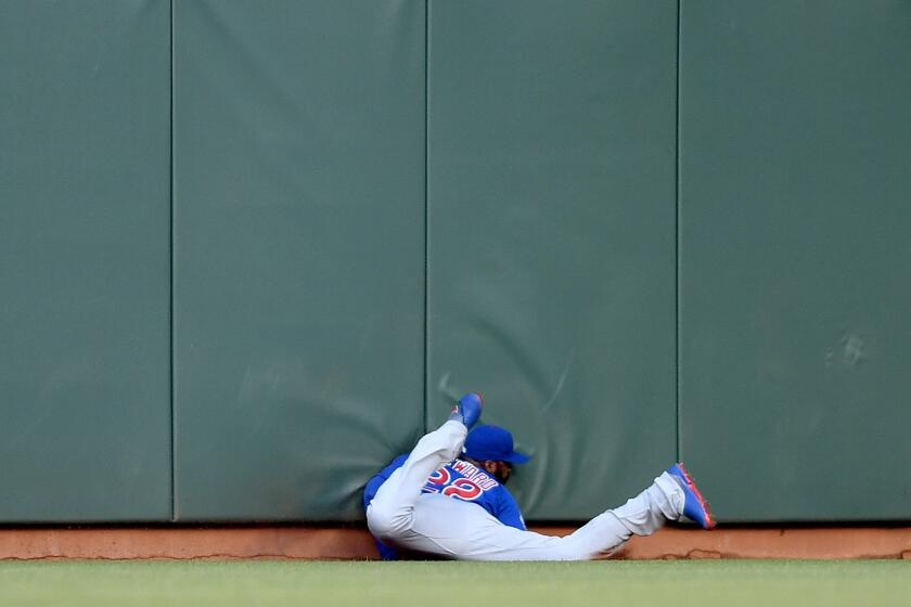 Cubs outfielder Jason Heyward slides into the wall while robbing Giants outfielder Denard Span of a hit during the first inning of a game on May 20 at AT&T Park.