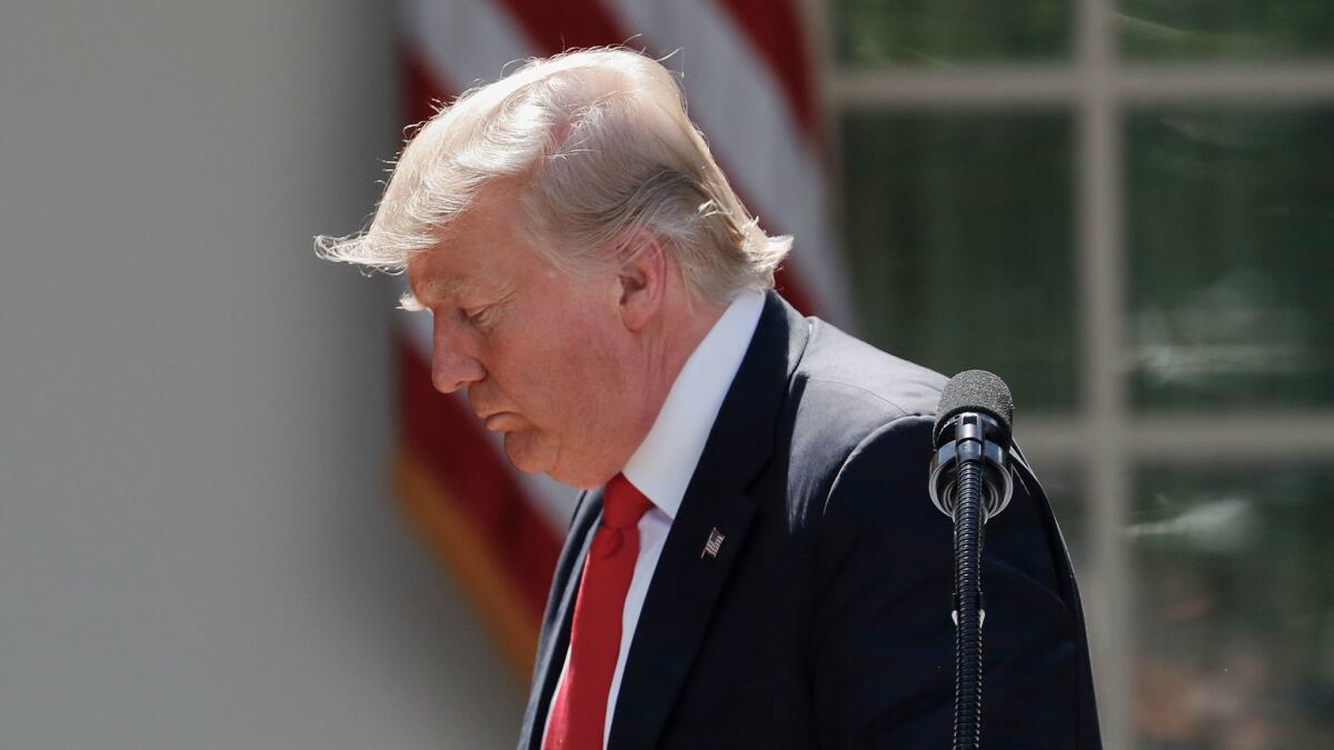President Donald Trump walks away from the podium after speaking about the U.S. role in the Paris climate change accord on June 1 in the Rose Garden of the White House.