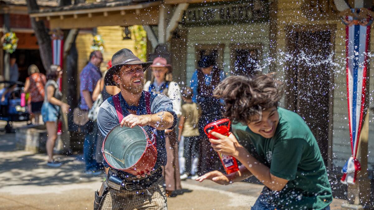  Alexis Rosales, of Bell gets drenched by Luke Brodowski, performing as Fluke Mayfield.