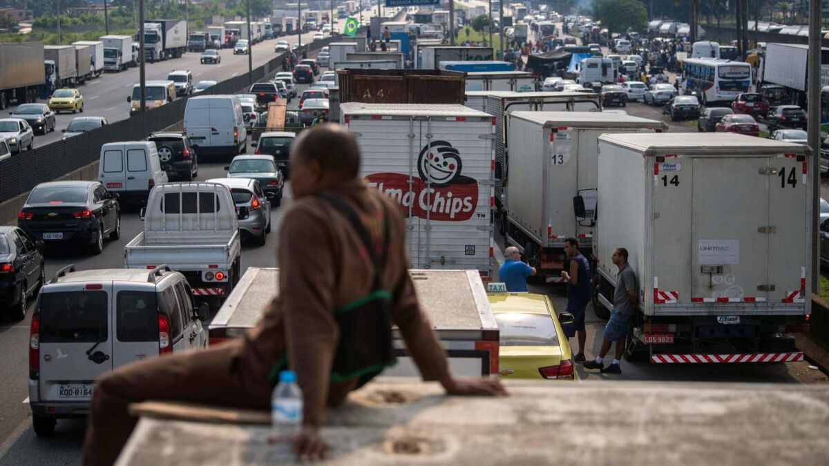 Brazilian truck drivers on Friday partially block a road in Duque de Caxias, a city near Rio de Janeiro, during the fifth day of their nationwide strike to protest rising fuel costs.