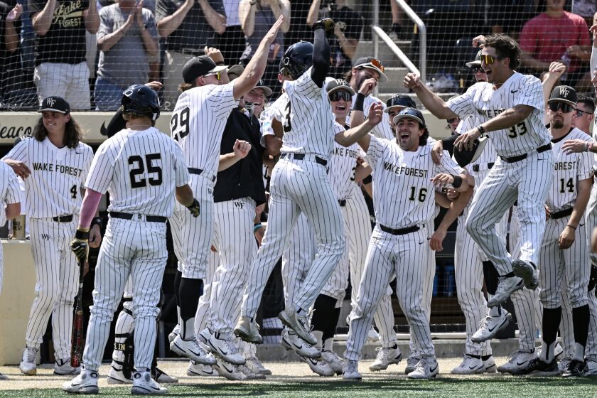 Wake Forest players celebrates after a home run by Danny Corona (3) during the fifth inning of an NCAA college baseball tournament super regional game against Alabama, Saturday, June 10, 2023, in Winston-Salem, N.C. (AP Photo/Matt Kelley)