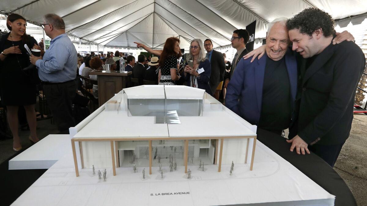 Architect Frank Gehry poses with Gustavo Dudamel, musical and artistic director of the Los Angeles Philharmonic Orchestra, last August when the Los Angeles Phil announced the new performance hall Gehry designed for the Youth Orchestra of Los Angeles.